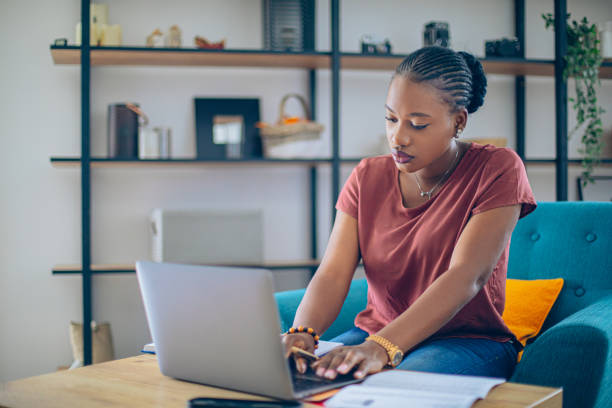 istock Young African woman doing her finances at home 1682734350