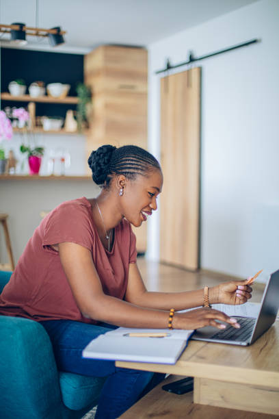 istock Young African woman doing her finances at home 1682734945