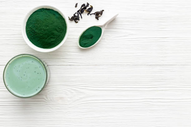 istock Spirulina algae powder in bowl and cold milk latte drink, top view 1682739399