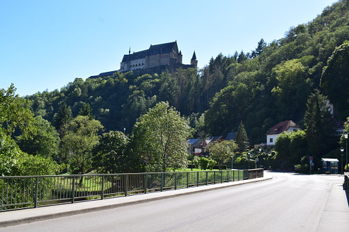 Vianden, Luxembourg - 08/10/2023: road from Our Valley into Vianden with the castle above the cliff at the main road