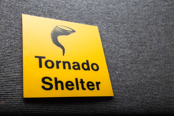 Yellow sign got a tornado shelter on a wall