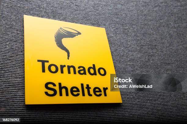 Yellow Sign Got A Tornado Shelter On A Wall Stock Photo - Download Image Now - Emergency Shelter, Windbreak, Tornado