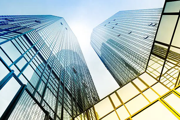 The sky’s the limit: looking up, futuristic glass and steel architecture, strong contrast, toned