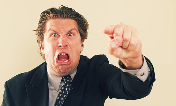 Bossy Man a bossy businessman pointing and screaming. cruel stock pictures, royalty-free photos & images