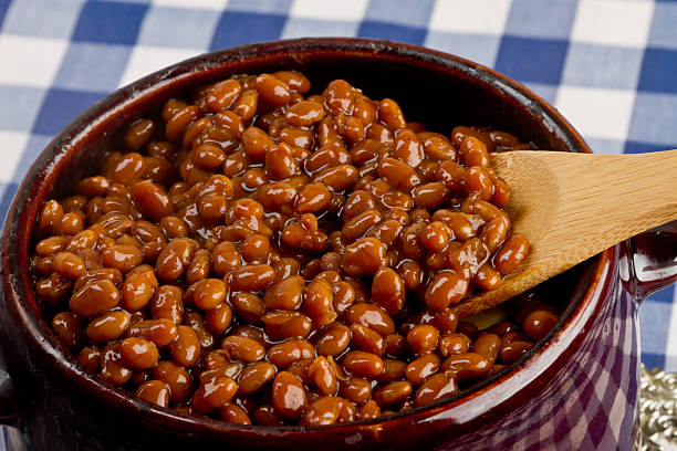 Pot of Baked Beans on a Blue Gingham Pot of Baked Beans on a Blue Gingham baked beans stock pictures, royalty-free photos & images