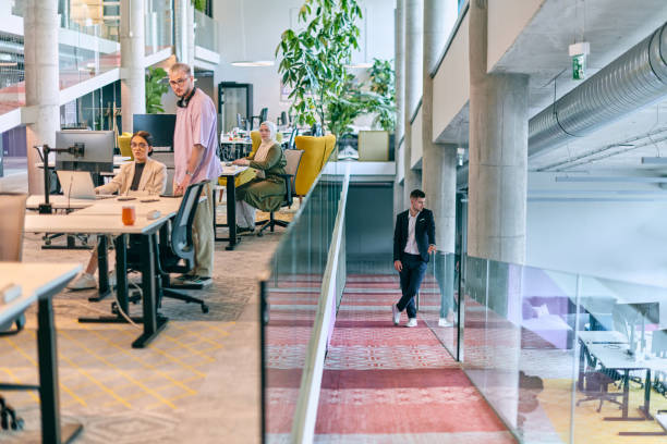istock In a modern startup office, a diverse group of young professionals collaboratively tackles various business problems and challenges, surrounded by their engaged colleagues, fostering innovation and productivity 1682774686