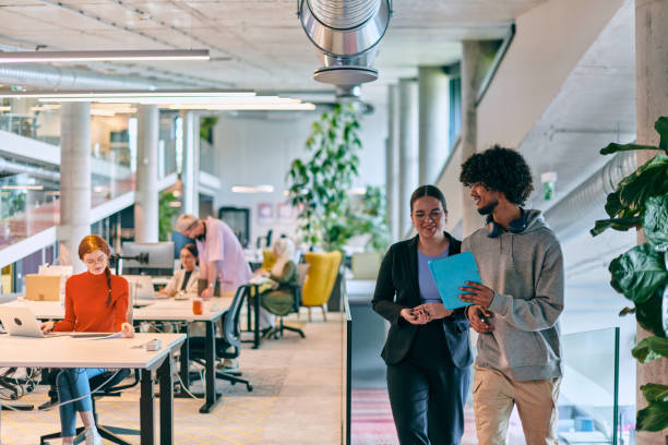 istock In a modern startup office, a diverse group of young professionals collaboratively tackles various business problems and challenges, surrounded by their engaged colleagues, fostering innovation and productivity 1682777196