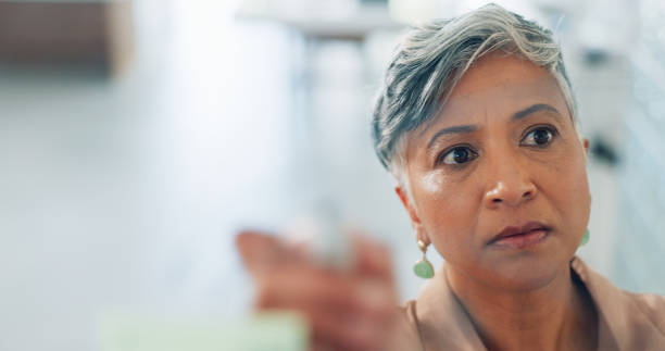 istock Thinking, idea and woman with sticky notes on for planning, strategy and brainstorming ideas. Post it, creative office and senior female worker writing for presentation, business meeting and schedule 1682777747
