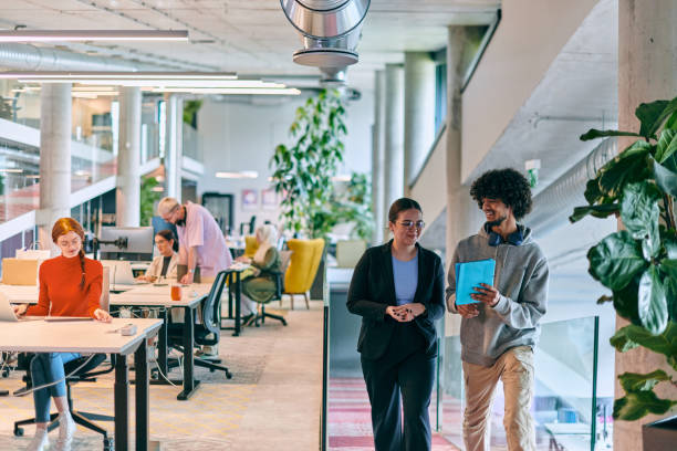 istock In a modern startup office, a diverse group of young professionals collaboratively tackles various business problems and challenges, surrounded by their engaged colleagues, fostering innovation and productivity 1682778539