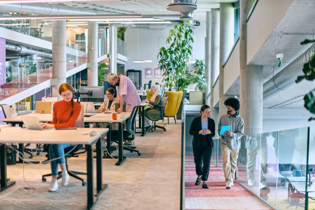 istock In a modern startup office, a diverse group of young professionals collaboratively tackles various business problems and challenges, surrounded by their engaged colleagues, fostering innovation and productivity 1682779687
