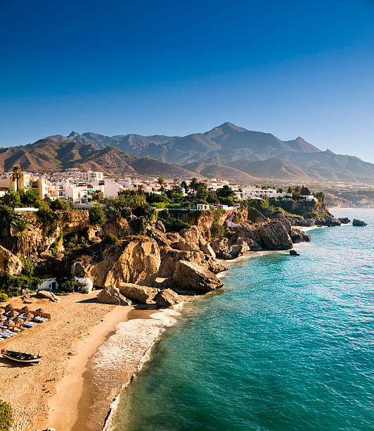 Nerja Beach at sunrise Nerja Beach in Andalucia (Spain) at sunrise. Sierra Nevada in the background malaga spain stock pictures, royalty-free photos & images