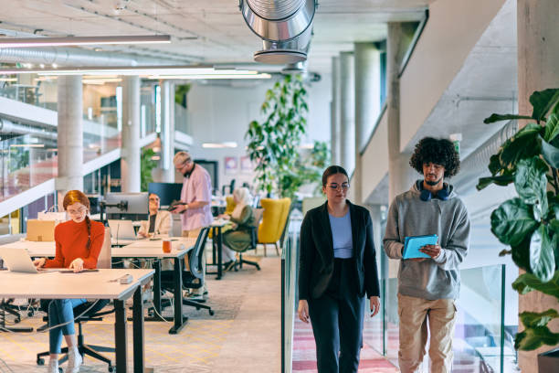 istock In a modern startup office, a diverse group of young professionals collaboratively tackles various business problems and challenges, surrounded by their engaged colleagues, fostering innovation and productivity 1682783082