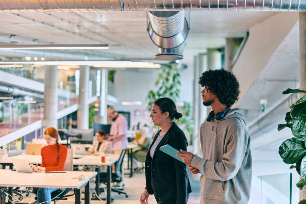istock In a modern startup office, a diverse group of young professionals collaboratively tackles various business problems and challenges, surrounded by their engaged colleagues, fostering innovation and productivity 1682784715