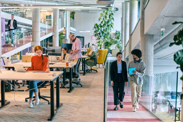 istock In a modern startup office, a diverse group of young professionals collaboratively tackles various business problems and challenges, surrounded by their engaged colleagues, fostering innovation and productivity 1682787536