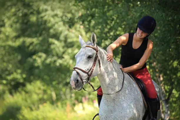 Girl horseback riding in the forest, Norway