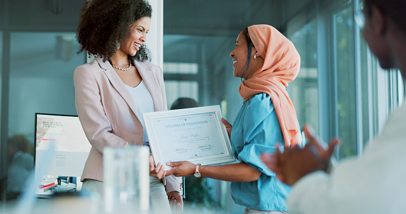 Award, winner and applause with a business black woman and team in celebration of the achievement of a male colleague. Thank you, meeting and support with a Muslim african american women being awarded a certificate