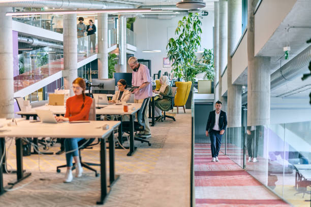 istock In a modern startup office, a diverse group of young professionals collaboratively tackles various business problems and challenges, surrounded by their engaged colleagues, fostering innovation and productivity 1682796471