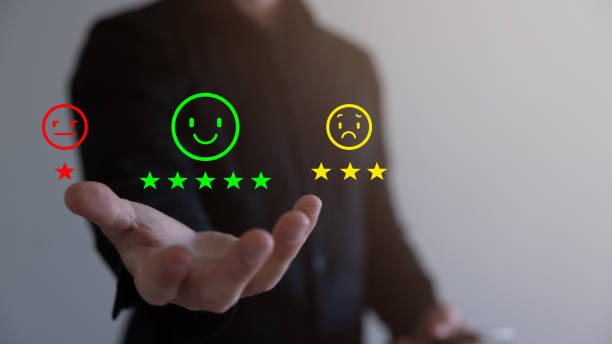 istock Customer Service and Satisfaction Concept Businessmen touch the virtual screen on happy smiley icons to achieve service satisfaction and feedback with excellent rated reviews. 1682801522