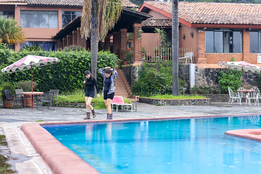 Young people walking near the pool
