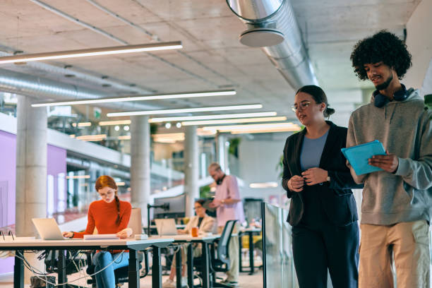 istock In a modern startup office, a diverse group of young professionals collaboratively tackles various business problems and challenges, surrounded by their engaged colleagues, fostering innovation and productivity 1682803692