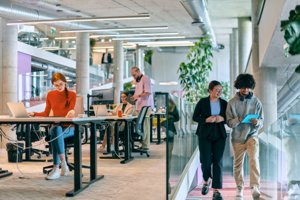 istock In a modern startup office, a diverse group of young professionals collaboratively tackles various business problems and challenges, surrounded by their engaged colleagues, fostering innovation and productivity 1682808105