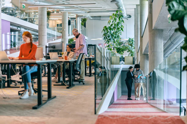 istock In a modern startup office, a diverse group of young professionals collaboratively tackles various business problems and challenges, surrounded by their engaged colleagues, fostering innovation and productivity 1682809273