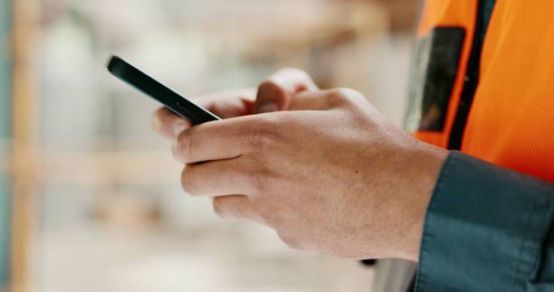 istock Closeup, architect and man with a smartphone, typing and construction worker with internet, social media or website information. Hands, person or engineer with a cellphone, digital app or mobile user 1682817085