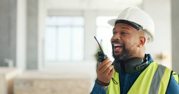 istock Building, walkie talkie and a black man construction worker on a site for project management or development. Communication, safety and an engineer talking on a radio for industrial architecture 1682817108