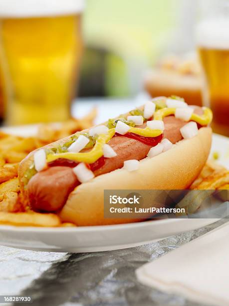 Loaded Hotdog With A Couple Of Beers Stock Photo - Download Image Now - Alcohol - Drink, American Culture, Barbecue - Meal