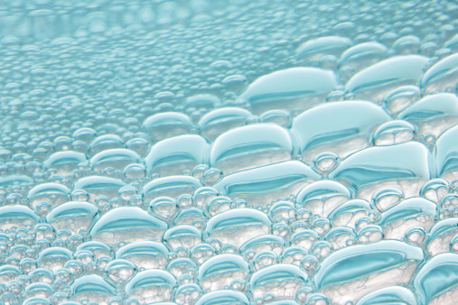 Beautiful Shiny Transparent Blue Soap Bubbles Background. Soap Sud Bubbles Water.