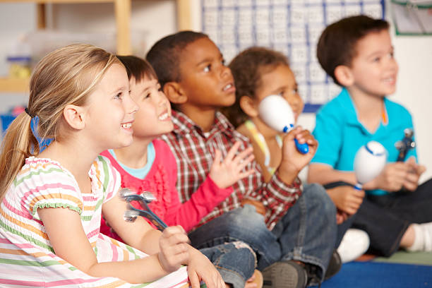 Group Of Elementary Age Schoolchildren In Music Class Group Of Elementary Age Schoolchildren In Music Class With Instruments music theory stock pictures, royalty-free photos & images