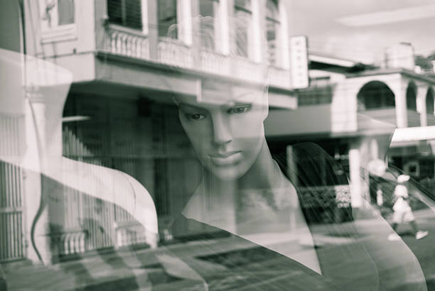 istock mannequin in deep thought reflected from shop glass 168282728
