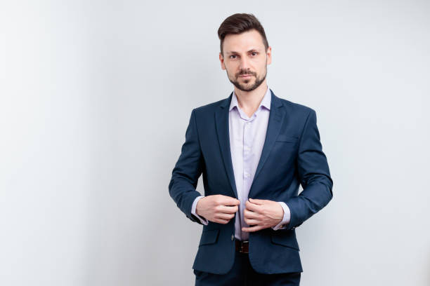 istock Handsome young man in suit posing against 1682833297