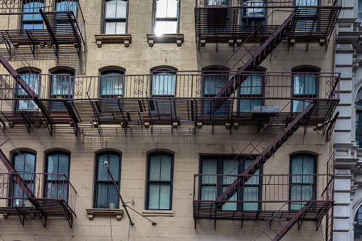 In Manhattan, a glimpse at a New York city residential building, with its famous  exterior fire escape staircase.