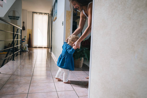 Mother helps baby walk