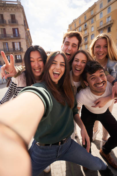 istock Vertical selfie of group young multi-ethnic friends having fun together outdoors. Excited people. 1682907714