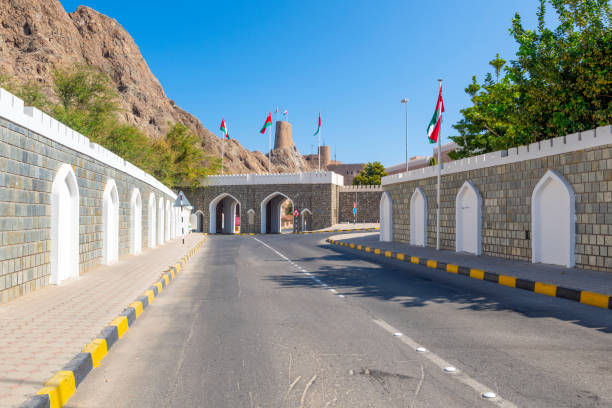 view of the al-mirani fort rising above the city gates in the old muscat region of muscat, oman. - al mirani imagens e fotografias de stock
