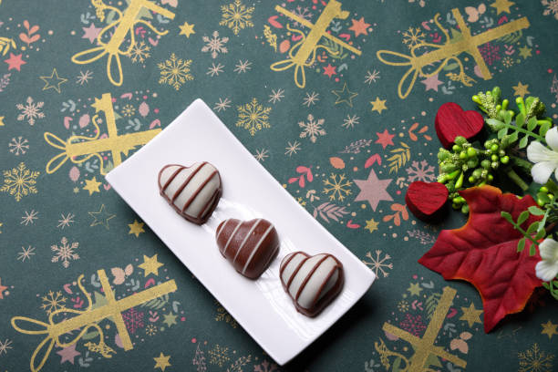 Ruby heart shaped chocolate truffles in rows gradually blended from dark to light shades of pink