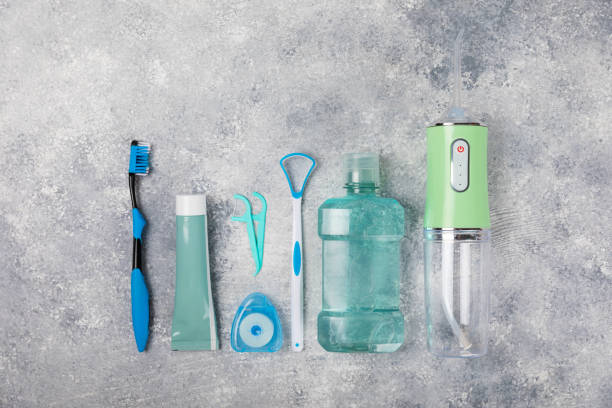 istock Electronic oral irrigator, toothbrush, paste, dental floss and mouthwash on a blue background. Dental tool for oral hygiene. Electric Interdental Cleaner. Dental water shower. Oral care concept. 1682942109