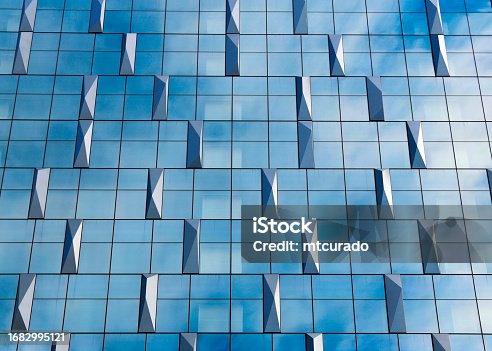 istock Glass façade with metal prisms - modern glass corporate building background 1682995121