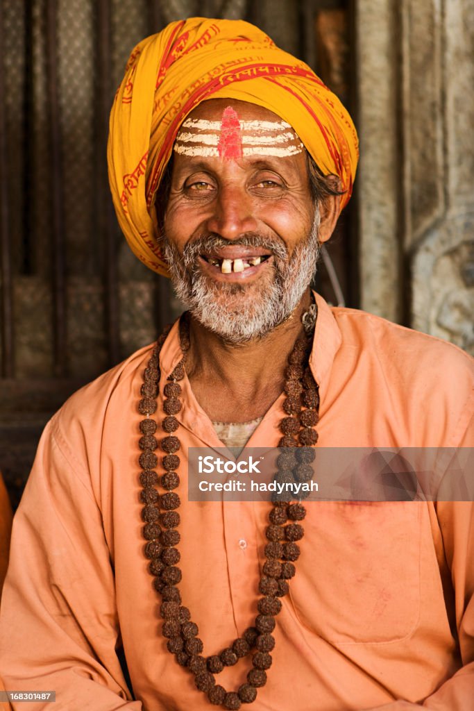 Sadhu - indian holyman sitting in the temple In Hinduism, sadhu, or shadhu is a common term for a mystic, an ascetic, practitioner of yoga (yogi) and/or wandering monks. The sadhu is solely dedicated to achieving the fourth and final Hindu goal of life, moksha (liberation), through meditation and contemplation of Brahman. Sadhus often wear ochre-colored clothing, symbolizing renunciation.http://bem.2be.pl/IS/nepal_380.jpg Adult Stock Photo