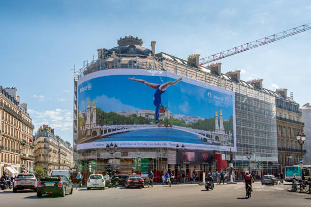 Giant advertising billboard sponsored by Allianz about the Paris 2024 Olympic games (gymnastics), Paris, France Paris, France - September 15, 2023: Giant advertising billboard sponsored by Allianz about the Paris 2024 Olympic games (gymnastics) on the scaffoldings of the restoration work of a parisian building teamwork slogan stock pictures, royalty-free photos & images