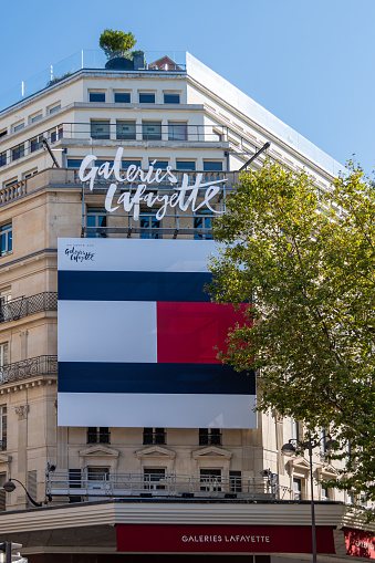 Paris, France - September 15, 2023: Tommy Hilfiger advertising billboard covering the facade of the Galeries Lafayette, a famous department store of Paris, France