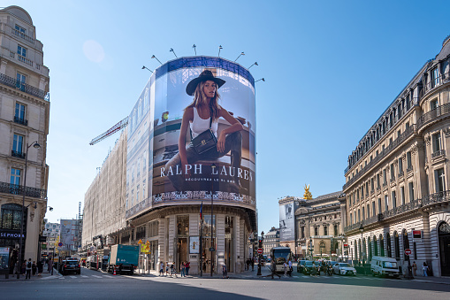 Paris, France - September 15, 2023: Giant advertising billboard for the new Ralph Lauren RL 888 bag covering the scaffoldings of the restoration works on the facade of a parisian building