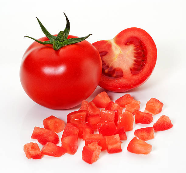 Ripe tomatoes Diced,whole and half tomatoes,on white background chopped food stock pictures, royalty-free photos & images