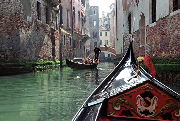 Gondola with tourists in Venice stock photo