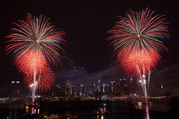 New York City Syncronized Fireworks July 4th on the Hudson River in front of Manhattan new years eve new york stock pictures, royalty-free photos & images