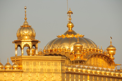 Telephoto image of domed Sikh monument roof at dawn.