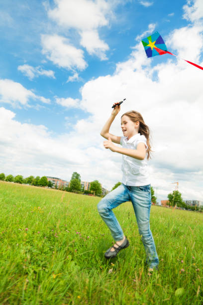 istock little girl flying a kite 168304897