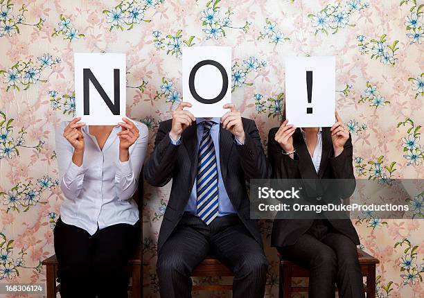 Three People Holding The Word No Over Their Faces Stock Photo - Download Image Now - Rejection, Negative Emotion, Job Interview